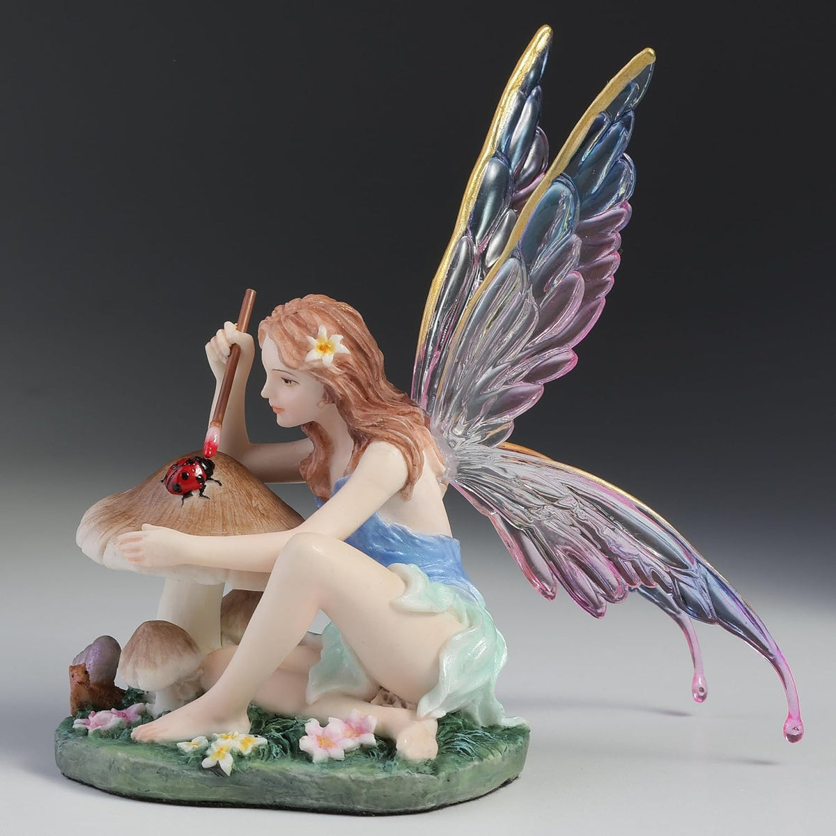 Chromatic Fairy Painting a Lady Bug Figurine